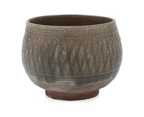 A THAI OLIVE-CELADON DEEP BOWL
Sawankhalok, 15th Century, a large olive glazed bowl with rounded sides, incised trellis patte