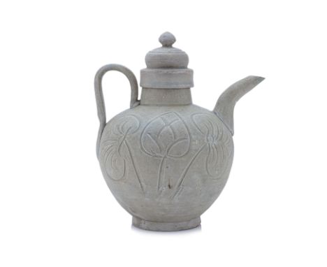 A CARVED GREEN-GLAZED CELADON EWER AND COVER
Song Dynasty or later, globular form with strap handle and curved spout, decorat