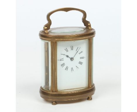 An early 20th century French brass cased oval carriage clock. With enamel dial and housing an 8 day movement with platform es