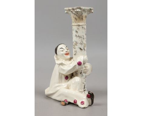 A French figural faience candlestick surmounted with Pierot stamped G. P. Paris.