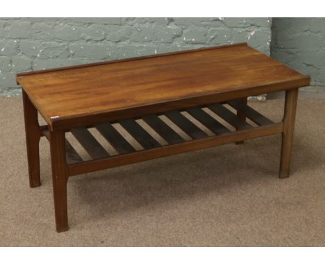 A 1970s teak two tier coffee table with magazine storage shelf.