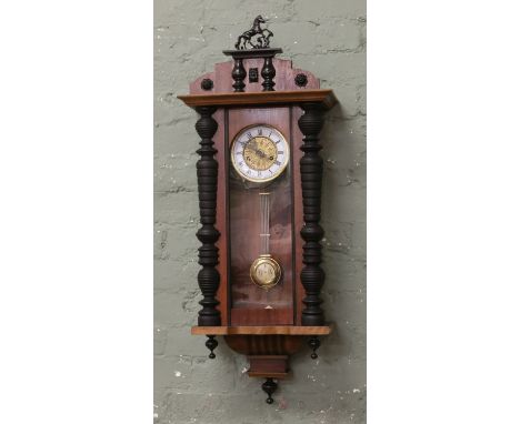 An early C20th D.R.G.M Vienna wall clock with eight day movement striking on a coiled gong, with key.