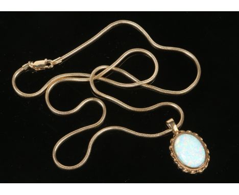 A 9 carat gold opal pendant on 9 carat gold snake chain. Gross weight 9.5 grams. 