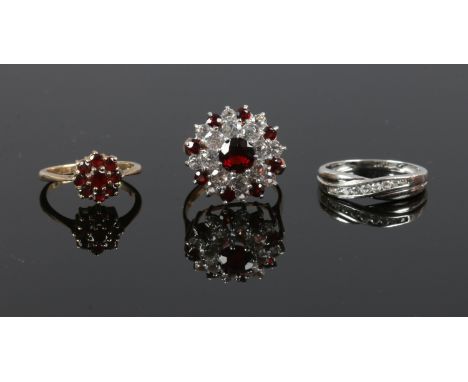 Three 9ct gold dress rings set with garnets and white paste stones.