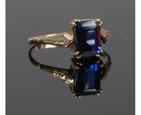 A 9ct gold dress ring. Set with a large rectangular cut blue gem stone, size O.