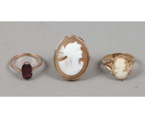 Two 9ct gold cameo dress rings and a 9ct gold garnet set ring.