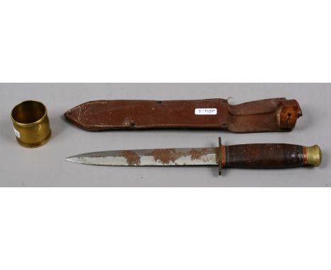 A hunting knife in leather scabbard. Presented to R. B. B. Warwick along with a H. M. S. Wild Swan brass serviette ring.