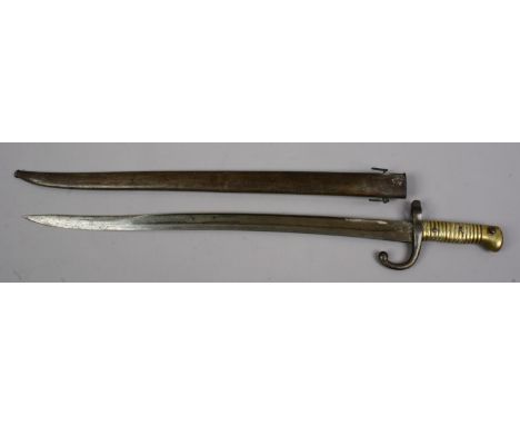 A C19th French sword bayonet with brass grip and in metal scabbard. Blade stamped P. M. & Co.