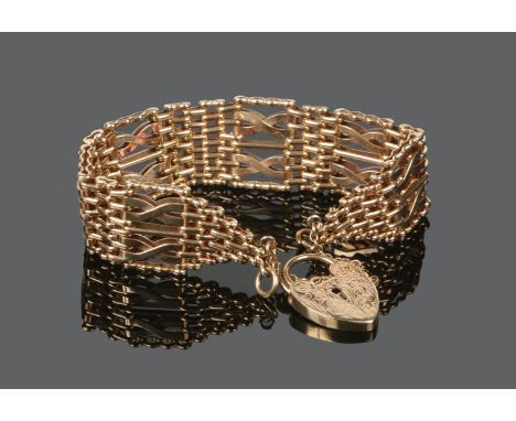 A 9 carat gold gate bracelet with engraved heart shaped clasp, 34 grams.  Condition Report. To be used as a guide only. Good 