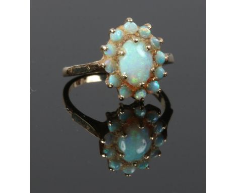 A 9 carat gold and opal set ring of floriform, size M gross weight 2.3 grams.