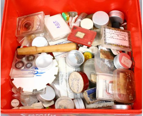 A box of assorted watch spares and tools. 