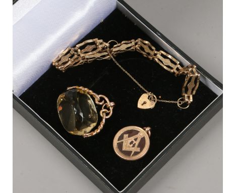 A 9ct gold gate bracelet with heart shaped clasp, 5 grams, a 9ct gold rotating lemon quartz fob and a gold and carnelian Maso