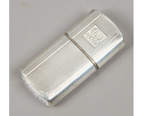 A vintage white metal cigarette lighter with engine turned decoration to the case.