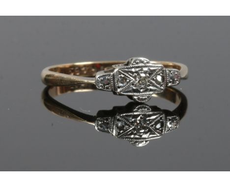 A 9ct gold and platinum Art Deco ring set with three diamonds. Size P.