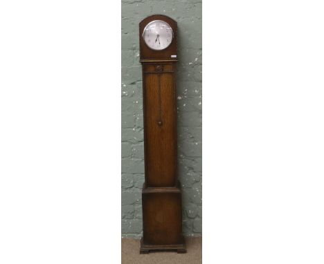 An oak cased granddaughter clock, with later quartz movement.