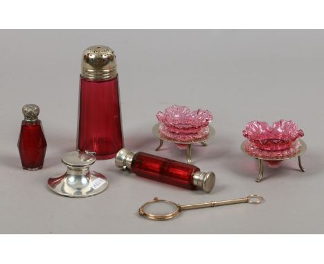 A collection of cranberry glass and white metal items including Victorian double ended scent bottle, a small silver captains 