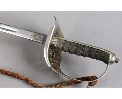 A World War I 1897 pattern officers infantry sword in leather mounted scabbard with etched blade and proof stamp.