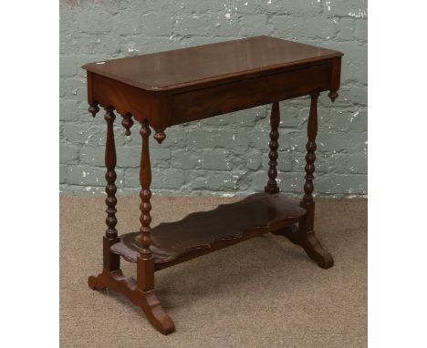 A Victorian mahogany two tier window table raised on bobbin turned supports.