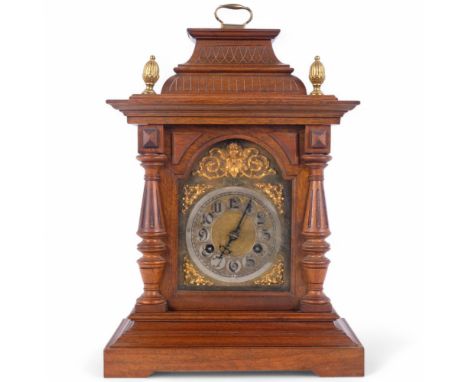 An early 20th century mahogany 8-day bracket clock, with label for Loffler Brothers of Kilburn, gilt-brass arch-top dial with