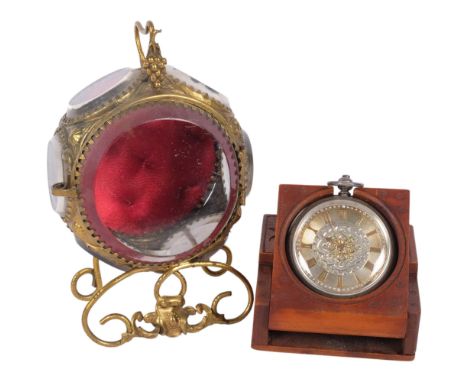 A Victorian brass bevelled glass pocket watch display stand, and a Black Forest travelling bedside pocket watch stand, with 1