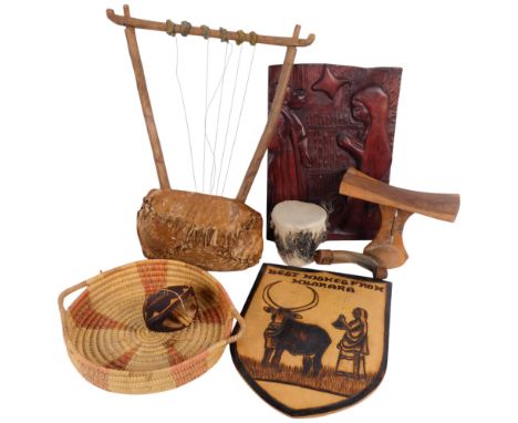 Various African pieces, including a carved shield, musical instrument, wicker tray, skin drum, etc