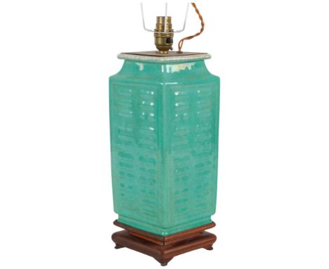 A Chinese 4-sided embossed green glazed pottery table lamp, on carved wood base, height to base of fitment 34cm