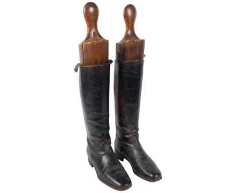 A pair of Vintage black leather riding boots, with wooden trees