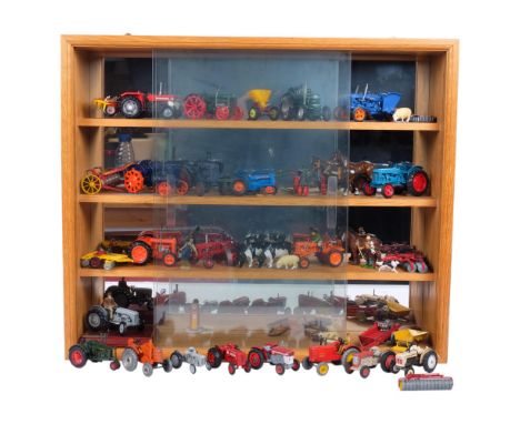 A collection of miniature diecast tractors, harrows, ploughs and other farm machinery, including Lesney, Dinky Toys, etc, in 