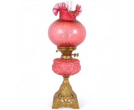 A Victorian Duplex brass cranberry glass oil lamp, with original moulded cranberry glass shamrock font, frilled cranberry gla