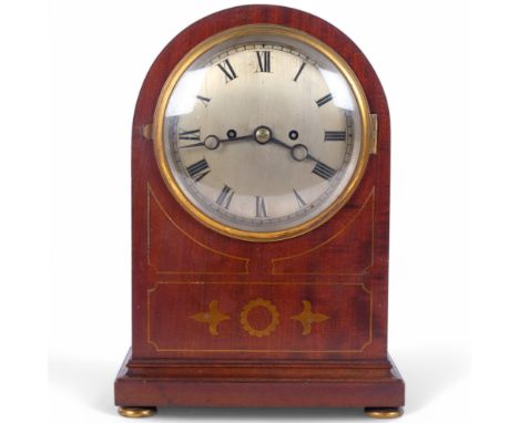 An early 20th century mahogany dome-top 8-day mantel clock, silvered dial with Roman numeral hour markers and inlaid case, ca