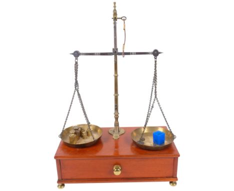 A set of brass balance scales by Cegrave of London, on mahogany stand with drawer, H57cm