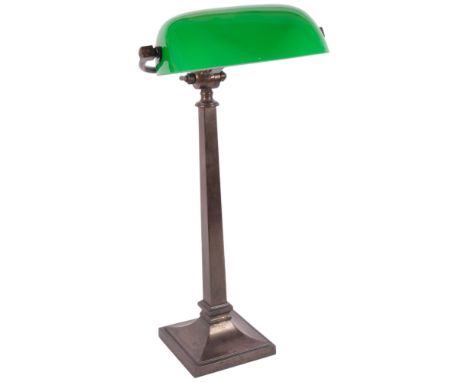 An early 20th century patinated brass student's table lamp, with green and white glass swivel shade, overall height 57cm