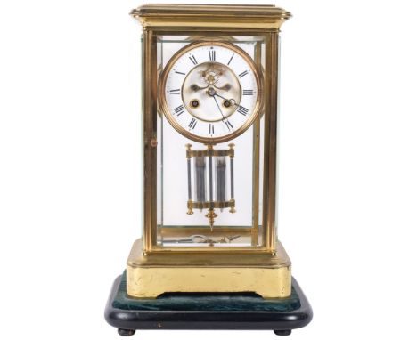 An early 20th C  gilt brass  four glass mantel clock with white enamel dial and roman numerals. Eight day striking movement w