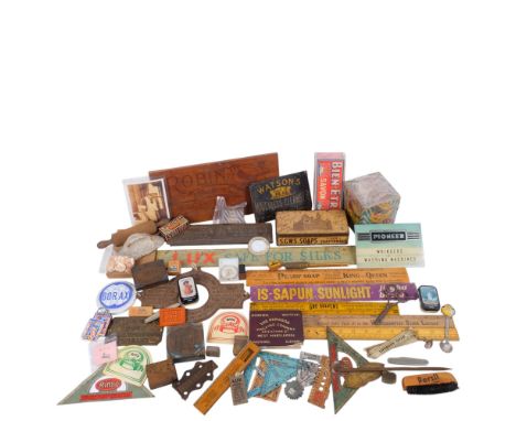 A collection of Vintage laundry items, including soap and starch advertising tins, copper print blocks on wooden bases, a Wat
