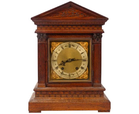 An oak-cased 8-day mantel clock, with carved columns and frieze, H42cm