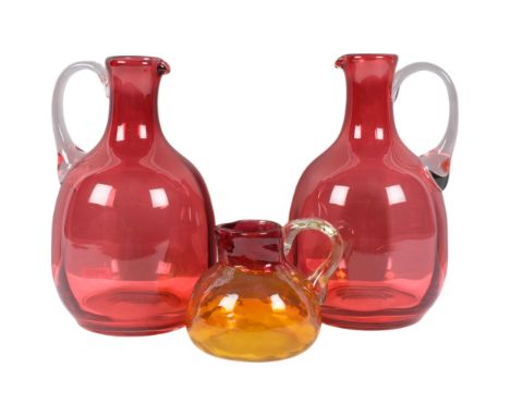 A pair of Vintage cranberry glass jugs, H20cm, and a small hand-blown glass jug
