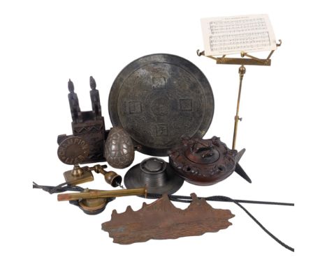 A Chinese bronze embossed circular mirror, 33cm, a pewter inkstand, a copper ship print block, Easter egg mould, candle holde