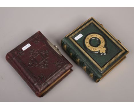 Two small Victorian photograph albums and contents of monochrome portrait photographs.
