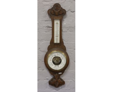 A carved oak wall barometer W. Greenwood Leeds.