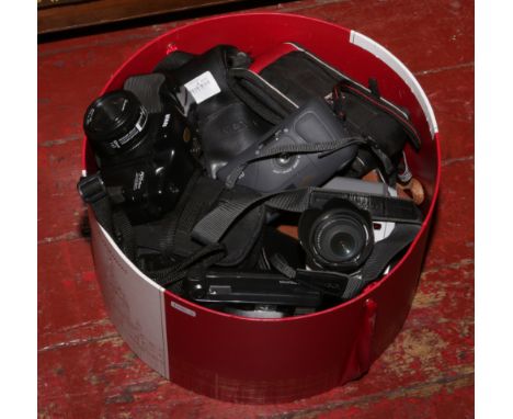 A box of camera equipment to include Kodak, Nikai, Canon, digital cameras etc.