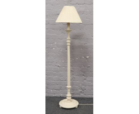 A white painted standard lamp with reeded and turned column.