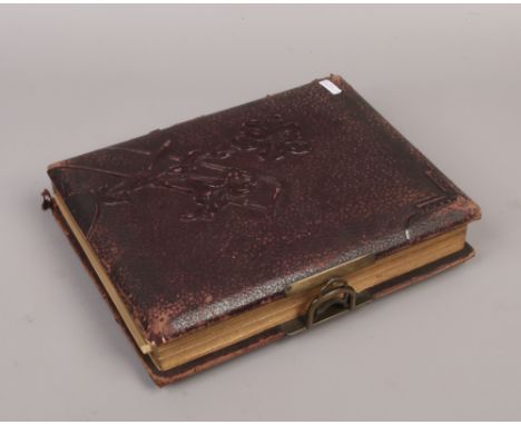 A late 19th / early 20th century photograph album and contents of monochrome portrait photographs.