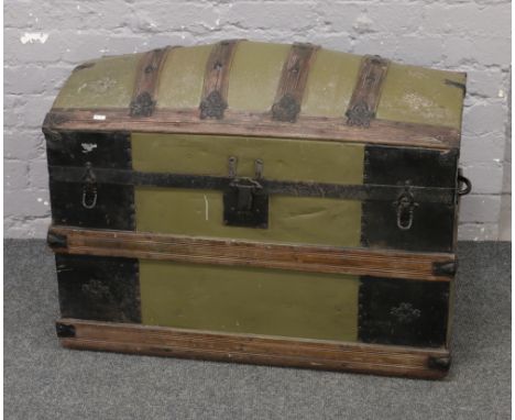 A painted metal bound dome top travel trunk.