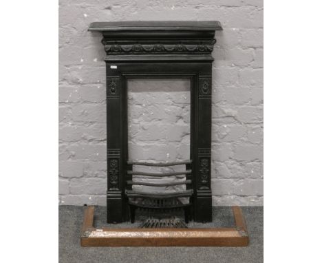 A Victorian cast iron bedroom fire place with shelf and grate, recently blacked, along with a copper finish fire fender.