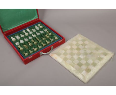 A cased onyx chess set with board.