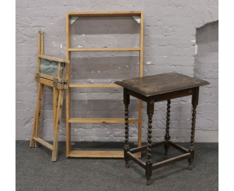 An oak barleytwist occasional table, folding directors chair and a wall mounted shelf.