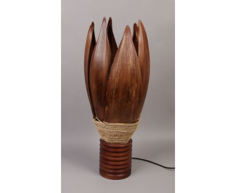 A Bali Island palm leaf table lamp with turned wood base and rope detail.