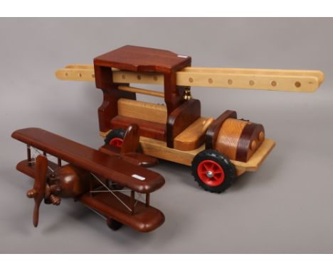 A wooden model of a fire engine, along with a wooden model of a bi plane.