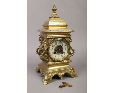 A French brass 8 day bracket clock with twin lion mask handles, enamelled chapter ring, having a cylinder movement and half h