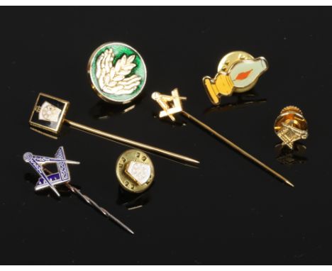 A collection of masonic stick pins and pin badges to include silver example.